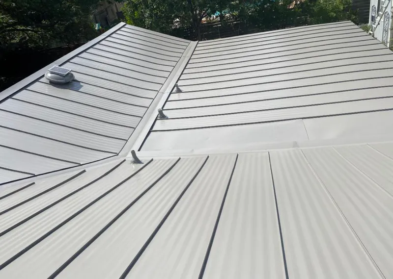 Solar attic fan installed on a metal roof for Roof Ventilation in Lawndale